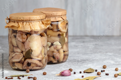 Canned mushroom. Marinated mushrooms in jar. Delicious pickled forest cep with herbs in tin. Organic vegetarian healthy kitchen. Natural edible ingredient for appetizer or snack. Autumn fungus