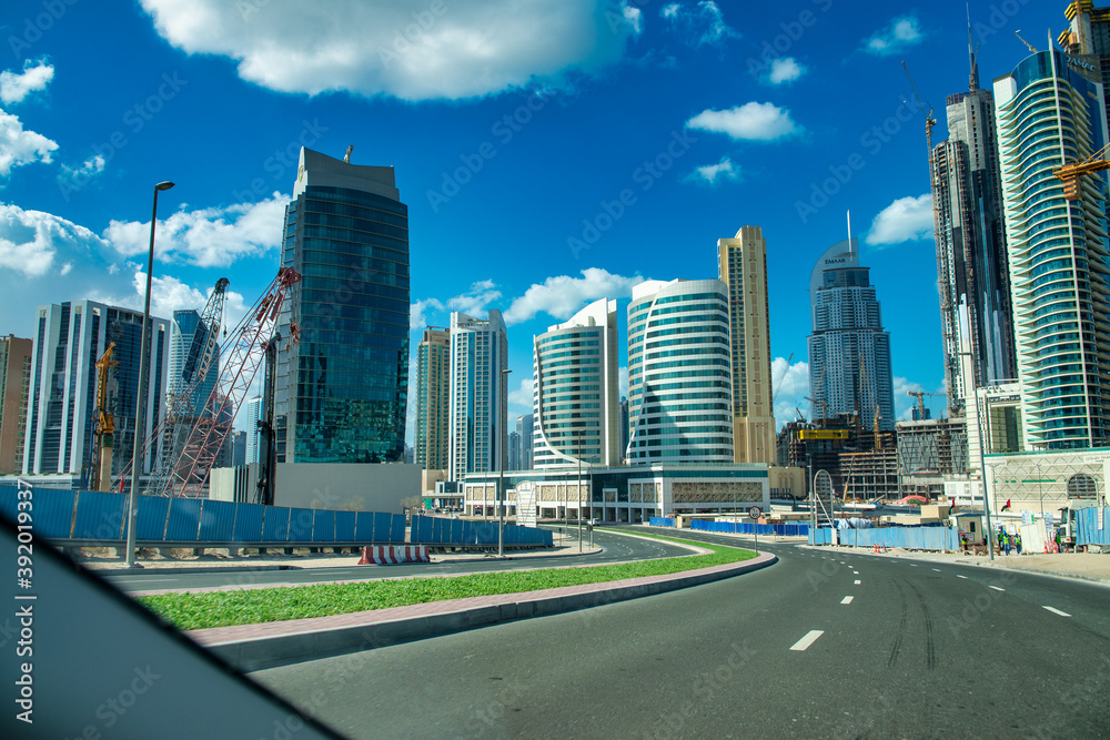 DUBAI, UAE - DECEMBER 10, 2016: Sheikh Zayed road traffic on a beautiful sunny day DUBAI, UAE - DECEMBER 10, 2016: Sheikh Zayed road traffic on a beautiful sunny day