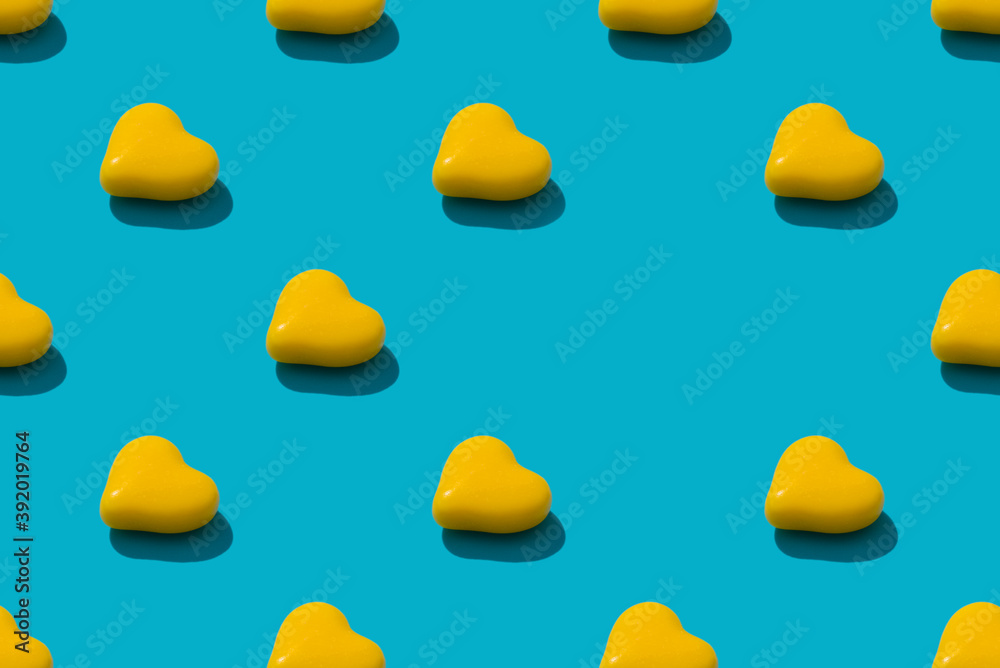 Composition background of yellow heart candy on the blue background. Valentine's Day concept. seamless p[attern
