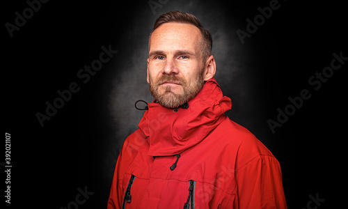 Handsome stylish man standing posing over dark background