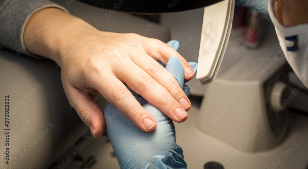 Process of manicure step by step. Instructions for making manicure. Beauty concept. Self-care concept. Close up of female hands. Safe manicure in gloves. Image for sites about beauty sphere