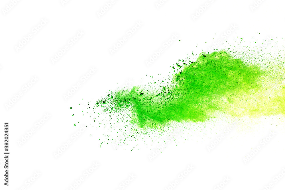 Freeze motion of green color powder exploding on white background. Freeze motion of green color powder exploding on white background.