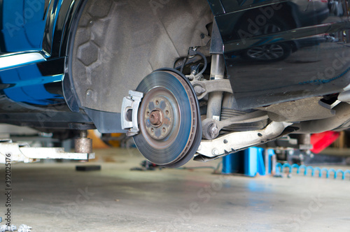 Car brake disc when changing wheels at a car service station.