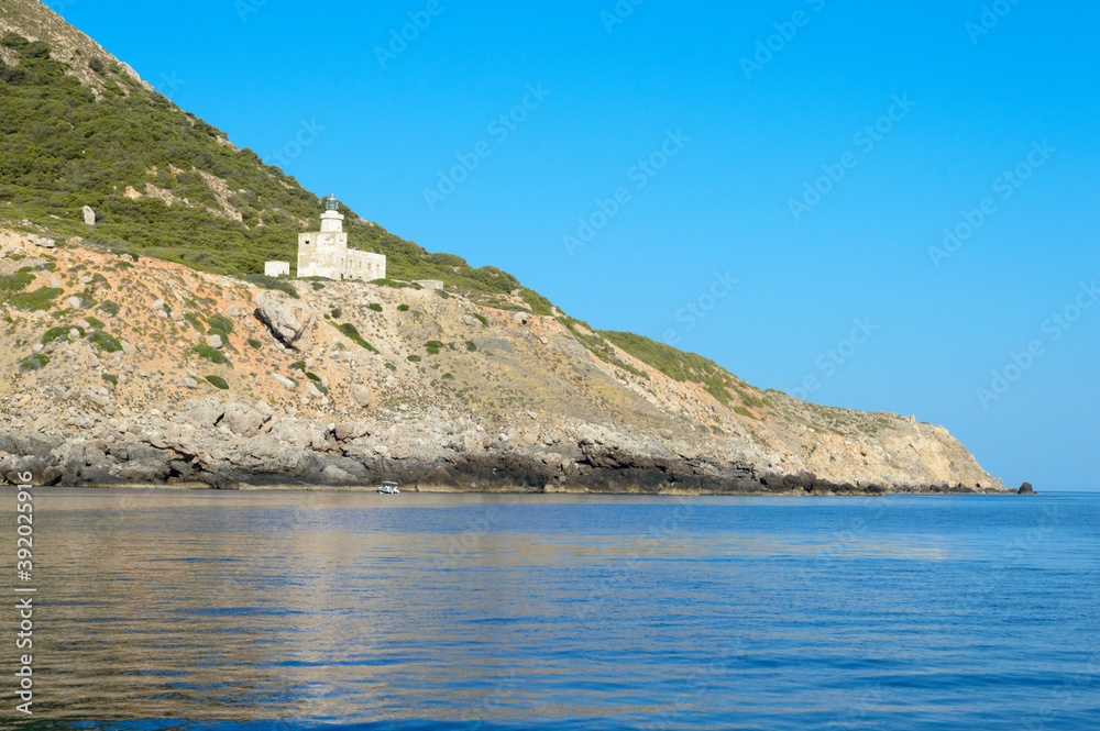 Rocky landscape of the little island of Marettimo in the Mediterranean sea. Here also the little white lighthouse known as Rocky landscape of the little island of Marettimo in the Mediterranean sea. Here also the little white lighthouse known as
