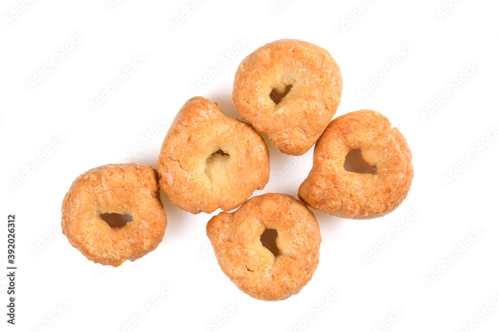 Taralli or tarallini, traditional italin snack from wheat dough. Some pieces close-up isolated on white background.