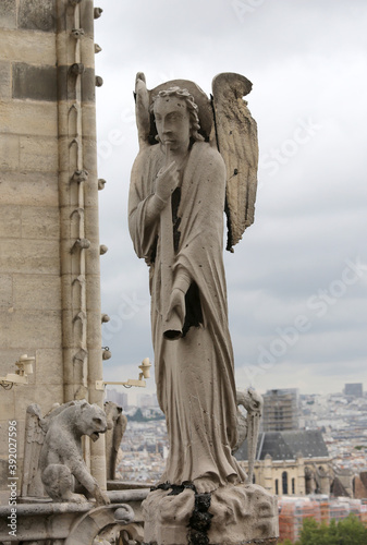 statue of a winged angel above the Notre Dame Cathedral in Paris