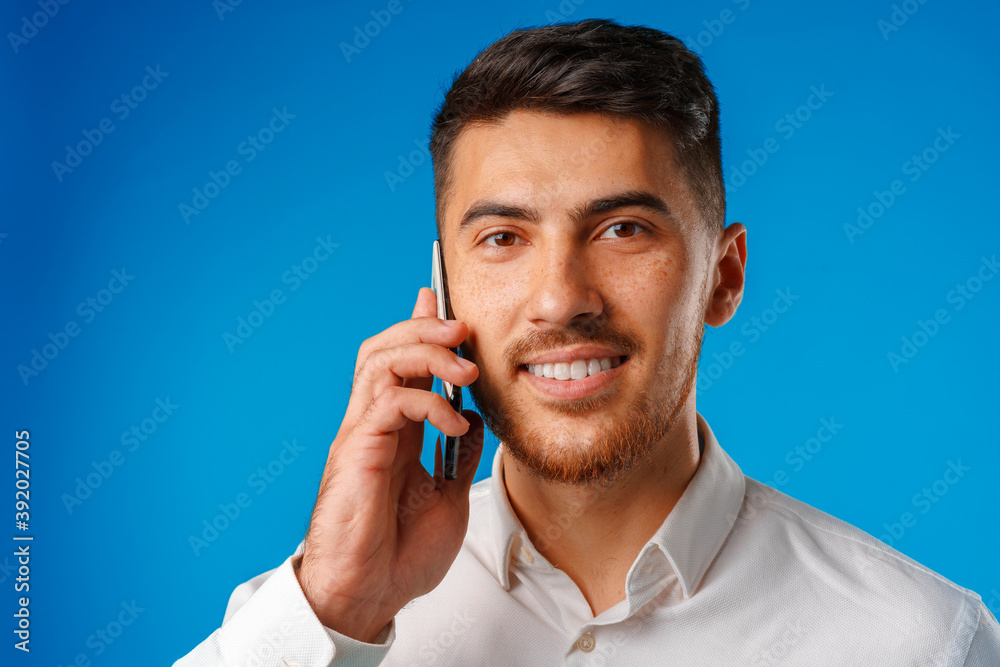 Porrtait of a young businessman having a phone conversation Porrtait of a young businessman having a phone conversation
