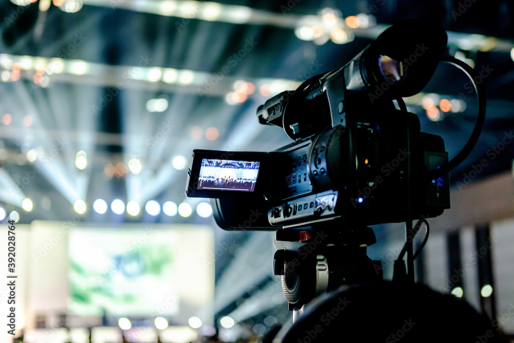 tv camera in a conference hall with spotlight tv camera in a conference hall with spotlight