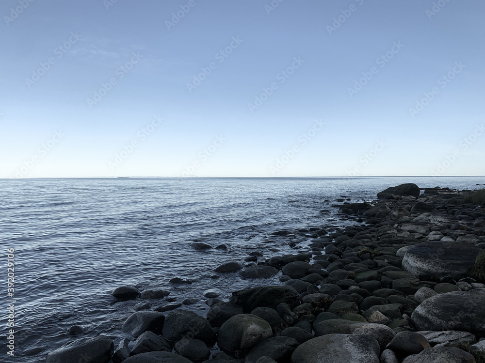 stone in the sea, peaceful blue seascape background