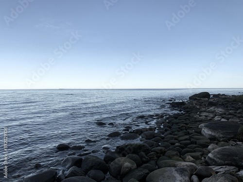 stone in the sea, peaceful blue seascape background