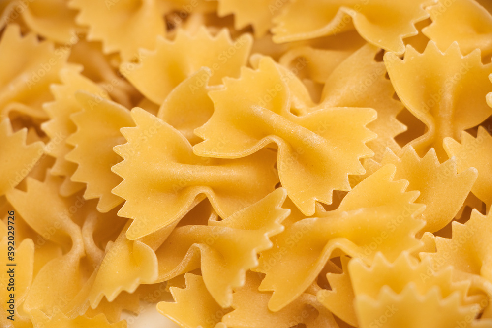 some farfalle pasta forming a background pattern some farfalle pasta forming a background pattern