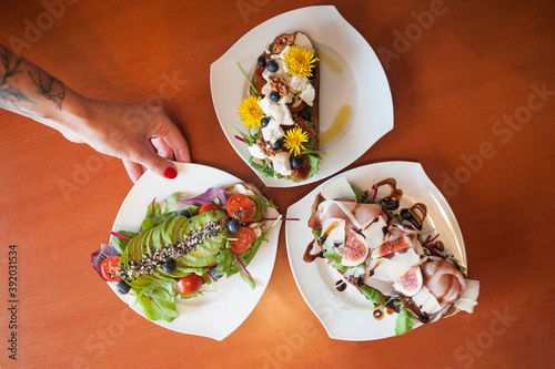 Delicious bread sandwitches served on table for breakfast, decorated with flowers.