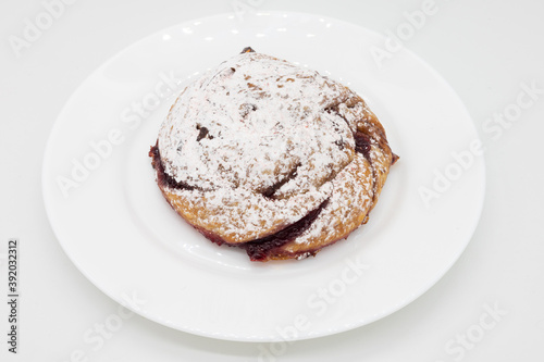 Raspberry Danish with Powdered Sugar on a White Plate