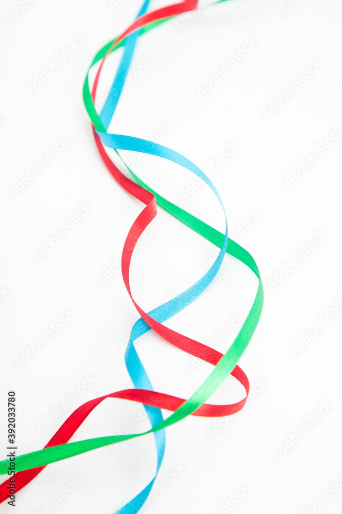 interweaving multicolored wavy ribbons on white with copy space