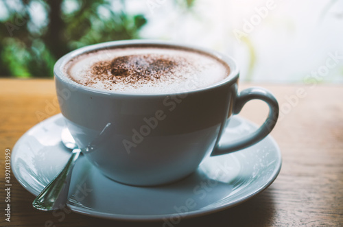 closeup coffee cup on wood table bar in restaurant or cafe with copy space. fresh beverage.