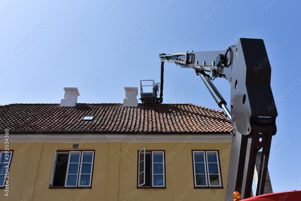Φωτογραφία boom and basket of telescopic aerial platform of service company by repair of ho