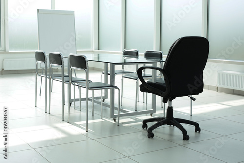 Flipchart glass table chairs in office space © Qwenergy