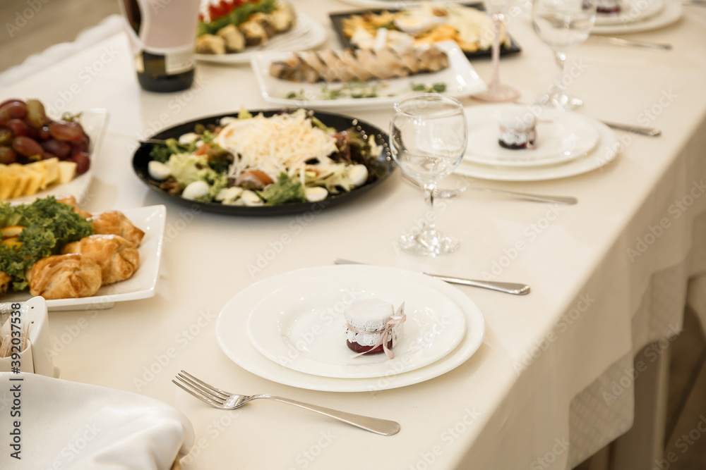 Nicely decorated banquet table with a variety of snacks and sandwich appetizers