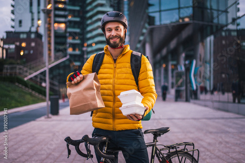 Fotografia Food delivery, rider with bicycle delivering food