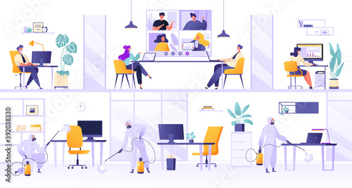 Working conditions in office during quarantine pandemic. Mask regime, distance and disinfection of premises. People sit at desks and work on computers in masks, with partitions between them.