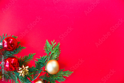 Christmas red background with fir tree and decor. Top view with copy space