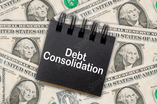 DEBT CONSOLIDATION text on Dollar Banknotes background. Business Concept