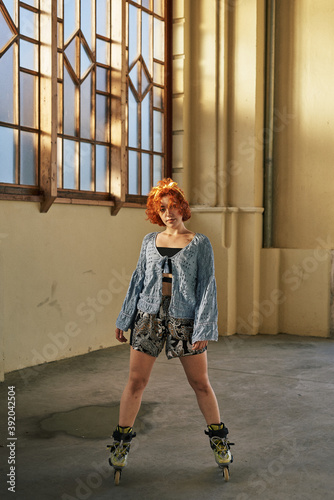 Young alternative redhead girl roller skater photo