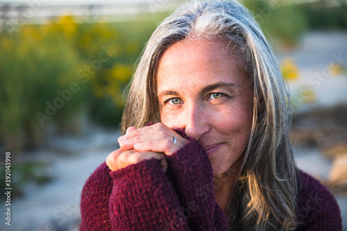Gray Haired Woman enjoying the beach at sunset