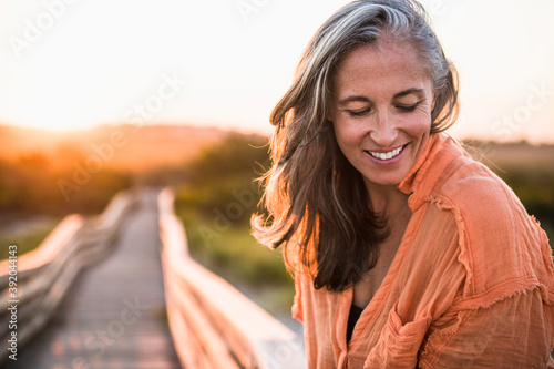 Portrait of Gray Haired Woman at the beach for sunset photo