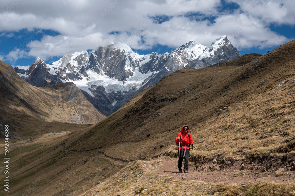 One person using poles hikes on a trail at Cordillera Huayhuash One person using poles hikes on a trail at Cordillera Huayhuash