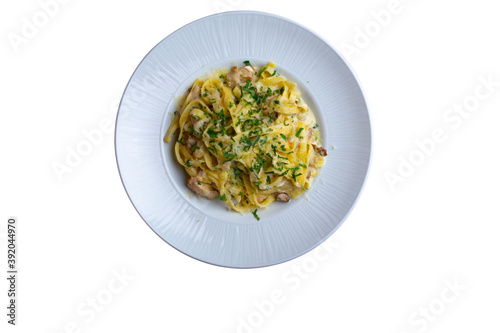 Tagliatelle with mushrooms, flavored herbs and parmesan, isolated white background.