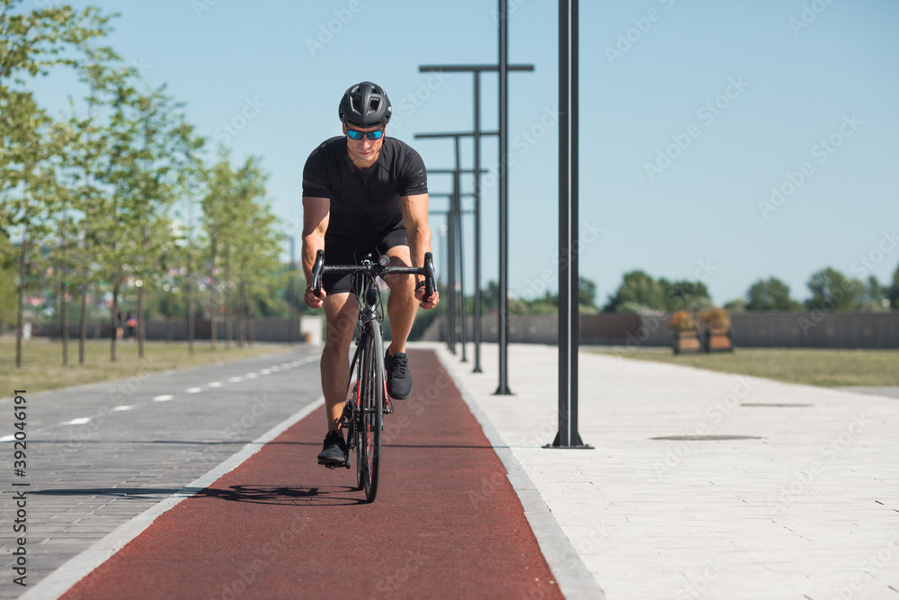 Obraz premium handsome young male in helmet and sunglasses with bike