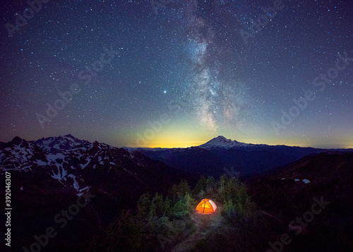 A tent is under the Milky Way on the top of a mountain, Washington, US