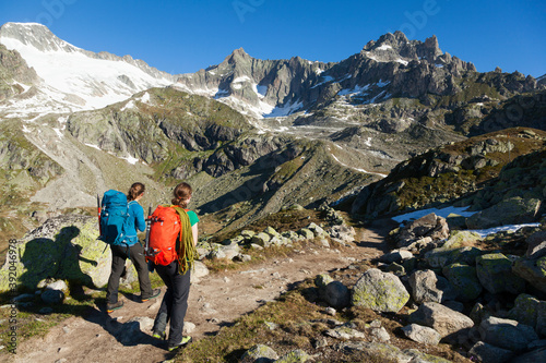 Climbers hike trail above Furka Pass, Uri, Switzerland photo