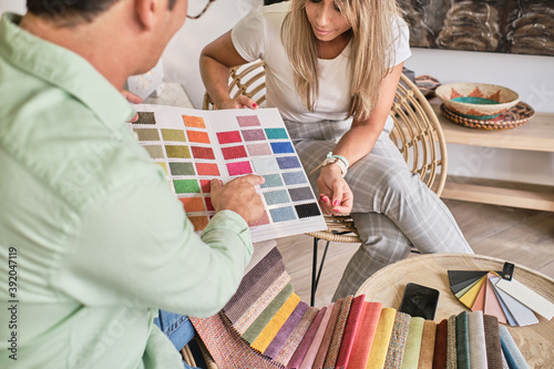 fabric salesman shows a lady the color chart photo