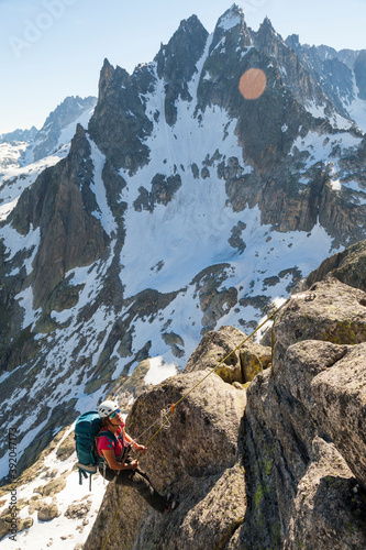Woman rappels from climbing on Lochberg, Furka Pass, Uri, Switzerland photo