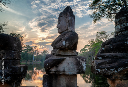 Angkor Archaeological Park, Siem Reap, Cambodia. South gate of Angkor Thom.  Good gods in hindu epic tale of a tug of war between good vs evil in the story the churning of the sea of milk. photo