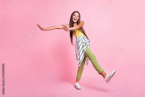 Fototapeta Naklejka Na Ścianę i Meble -  Full length photo of pretty cheerful girl have fun spend holiday wear green pants isolated on shine pink color background