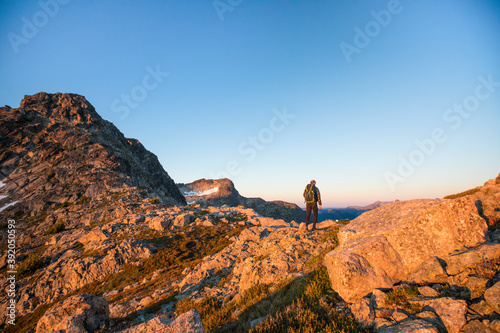Rear view of backpacker exploring mountain range.