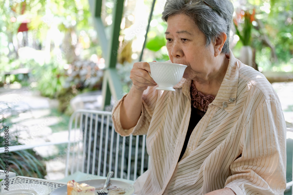 old elderly senior elder woman drinking hot mocha coffee tea at restaurant. old elderly senior elder woman drinking hot mocha coffee tea at restaurant.