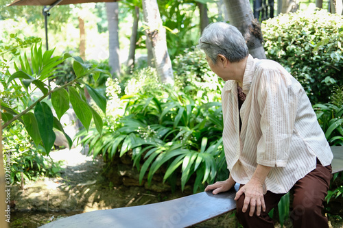 elder woman resting in garden. elderly female relaxing outdoors. senior leisure lifestyle