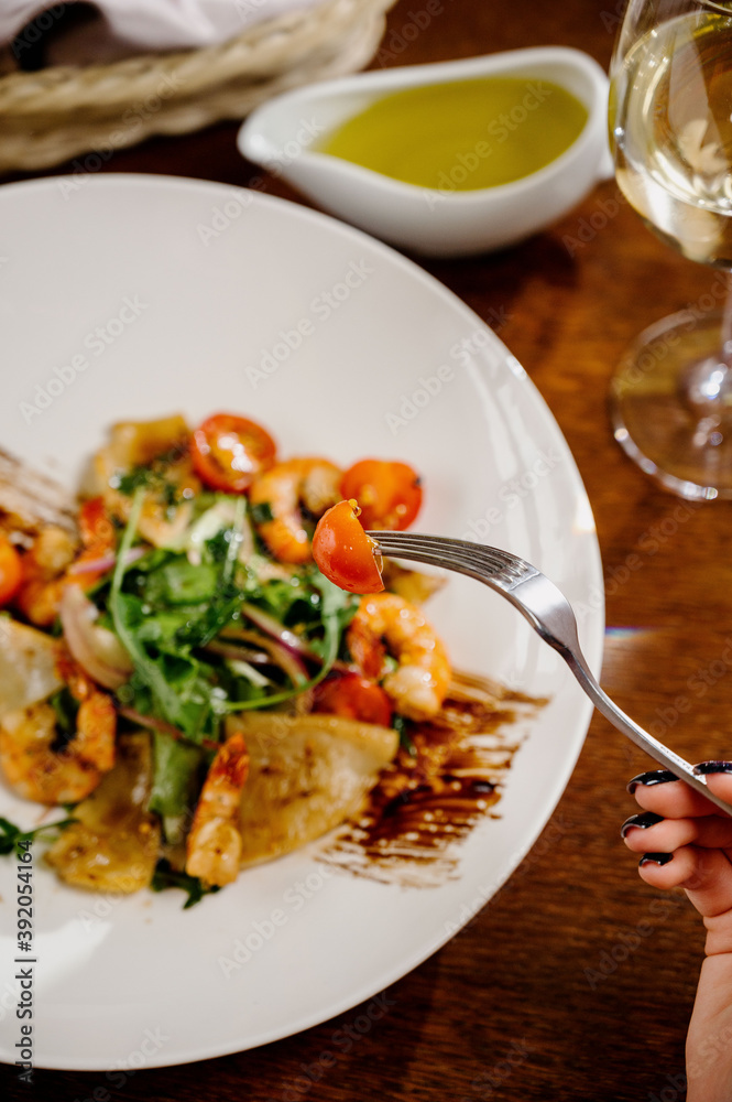 Fresh salad plate with shrimp, tomato and mixed greens on wooden background close up. Healthy food. Clean eating. Fresh salad plate with shrimp, tomato and mixed greens on wooden background close up. Healthy food. Clean eating.