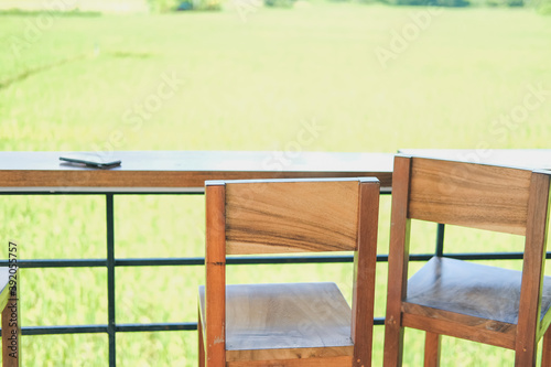 wooden chair on terrace with rice paddy field view