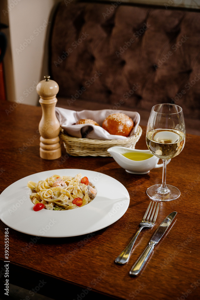Plate with delicious Chicken Alfredo on table