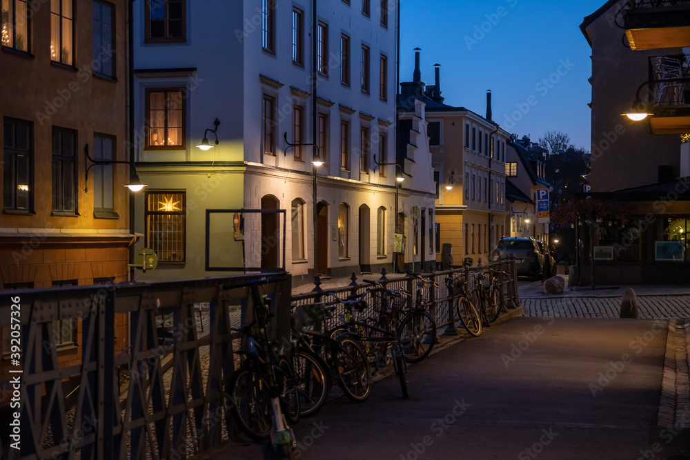 Scenic view of the evening street in Stockholm. Bicycles are parked along the fence