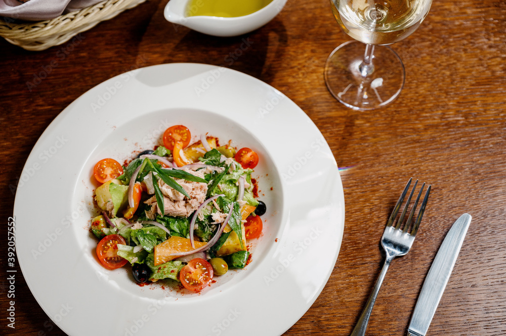 Caesar salad with croutons, quail eggs, cherry tomatoes and grilled chicken in wooden table Caesar salad with croutons, quail eggs, cherry tomatoes and grilled chicken in wooden table