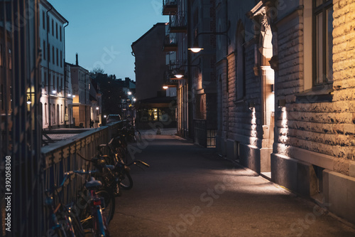 Scenic view of the evening street in Stockholm. Bicycles are parked along the fence © bbgreg