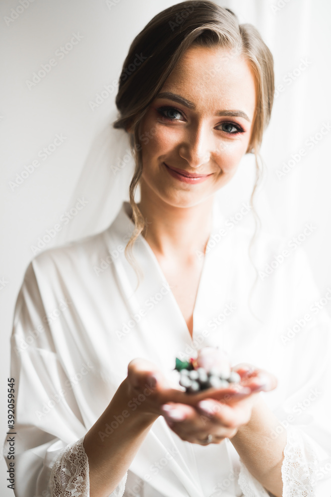 Beautiful bride wearing fashion wedding dress with feathers with luxury delight make-up and hairstyle, studio indoor photo shoot Beautiful bride wearing fashion wedding dress with feathers with luxury delight make-up and hairstyle, studio indoor photo shoot