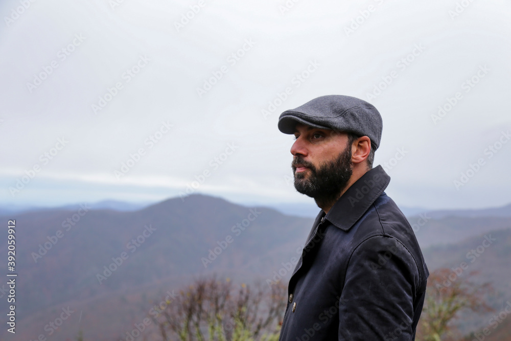 Young handsome man outdoors in fall clothing with autumn natural surroundings 