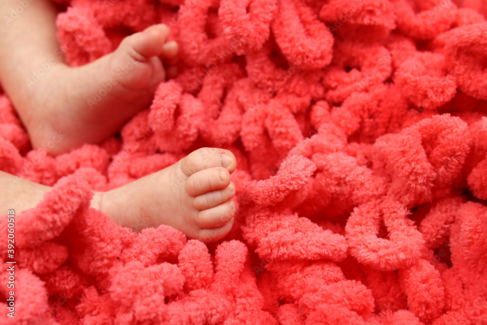 Tender sensitive baby feet on the bedspread Tender sensitive baby feet on the bedspread